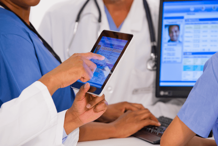 Image of healthcare workers reviewing information on a tablet